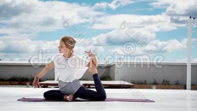 做瑜伽或普拉提运动的年轻女子一条腿的鸽子姿势